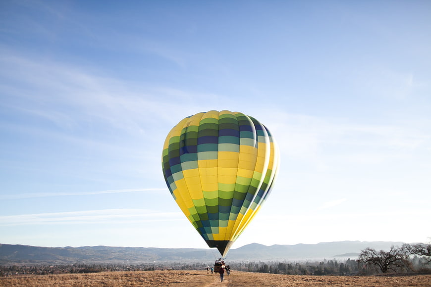 Colorful hot air balloon inflating in a field