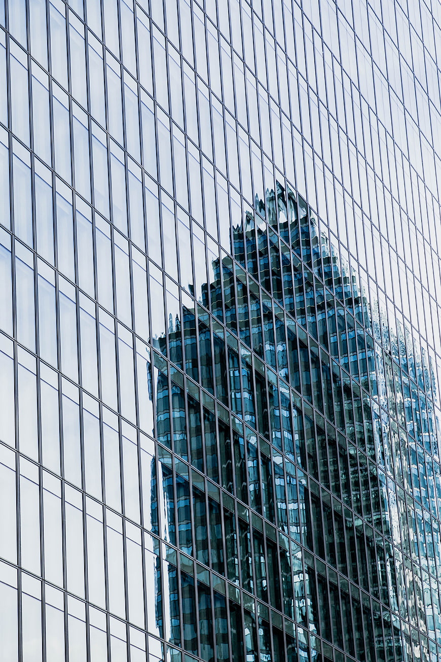 Abstract Reflection of Skyscraper on Glass Building Facade
