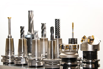 Industrial CNC Cutting Tools And Drills Arranged On White Background