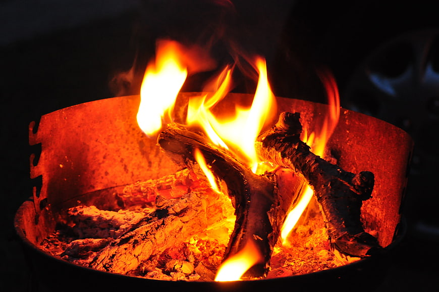 Close-up of burning wood fire in metal brazier