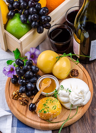 Gourmet Cheese Board With Wine, Grapes, Honey, And Fresh Flowers