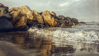 Golden Rocks on Beach with Crashing Waves and Reflections