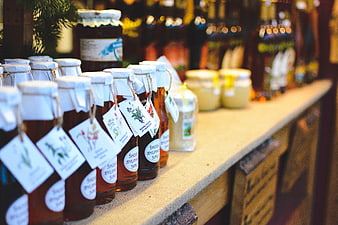 Natural herbal syrups on wooden shelf at Christmas market