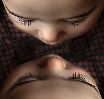 Close-up of two sleeping babies with closed eyes and long eyelashes
