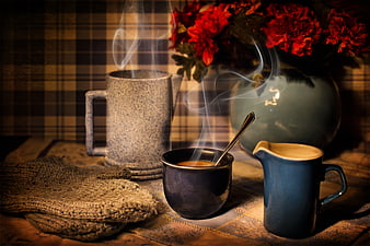 Cozy winter morning coffee with red flowers and plaid background