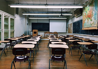 Empty Classroom with Desks, Blackboard, and World Map