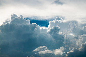 Dramatic blue sky with fluffy white cumulus clouds