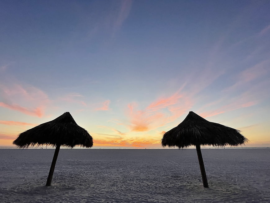 Silhouetted Thatched Beach Umbrellas at Sunset