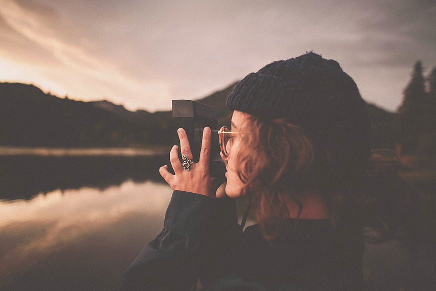Woman Photographer Taking Photo at Sunset by Lake