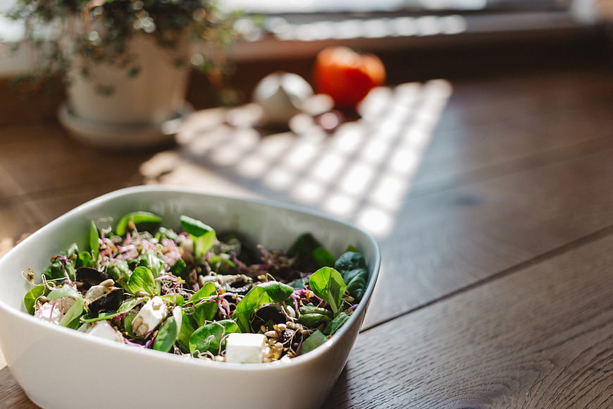 Fresh Green Salad Bowl on Wooden Table with Natural Light