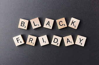 Black Friday spelled with wooden letter tiles on dark background