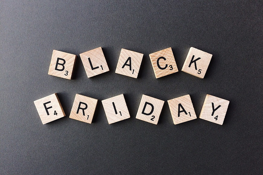 Black Friday spelled with wooden letter tiles on dark background