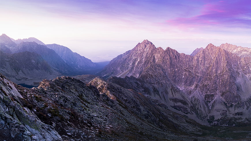 Majestic Mountain Peaks at Twilight with Purple Sky