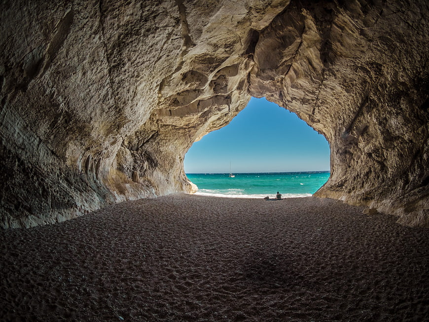 View from inside a sea cave looking out to turquoise ocean
