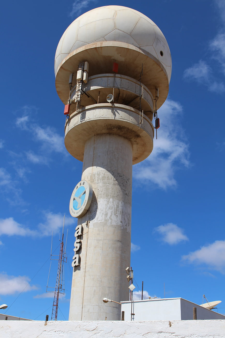 Concrete Radar Tower with Dome Against Blue Sky