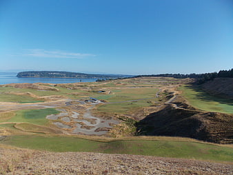 Aerial View of Coastal Golf Course with Ocean and Hills