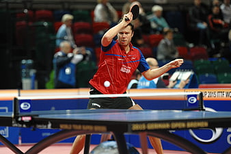 Male Table Tennis Player Serving in Red Jersey