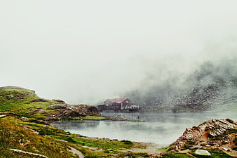 Misty Mountain Lake with Lodge and Hikers