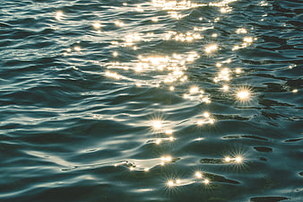 Sparkling Sunlight on Rippling Ocean Water Surface