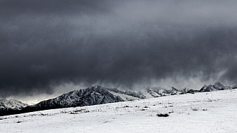 Dramatic Winter Storm Over Snowy Mountain Range