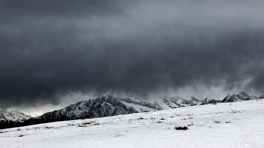 Dramatic Winter Storm Over Snowy Mountain Range