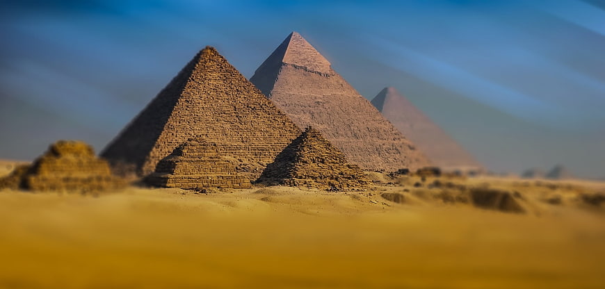 Miniature tilt-shift effect of Giza pyramids in golden desert