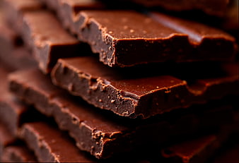 Close-up of stacked dark chocolate pieces with rich texture
