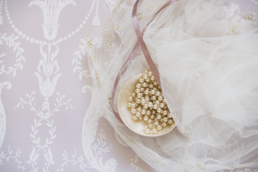 Elegant Wedding Veil with Pearls on Patterned Background
