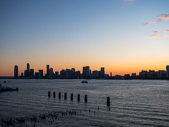 City Skyline Silhouette at Sunset Over River