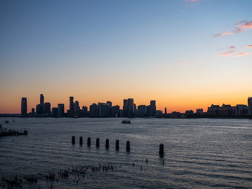 City Skyline Silhouette at Sunset Over River