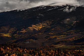 Dramatic Autumn Mountain Landscape with Snow-Capped Peaks
