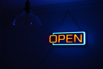 Glowing Neon Open Sign in Dark Blue Room