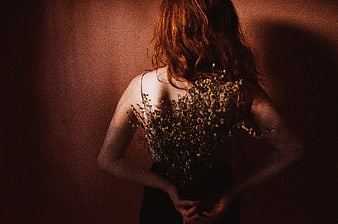 Woman with Red Hair Holding Dried Flowers from Behind