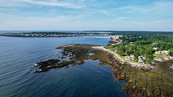 Aerial View of Rocky Coastal Town with Ocean and Beach