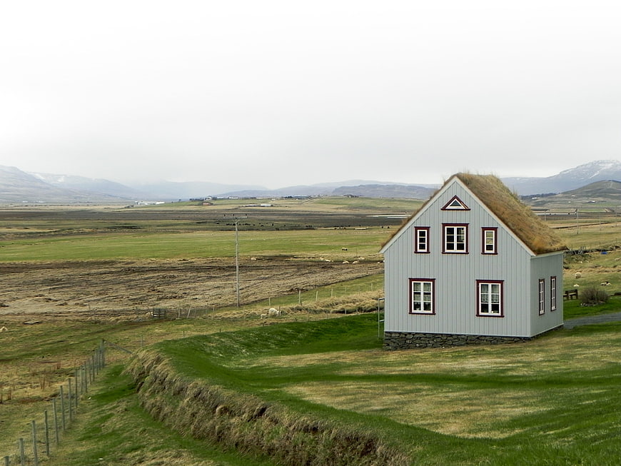 Traditional Icelandic turf house in green landscape