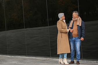Happy senior couple walking together in autumn fashion