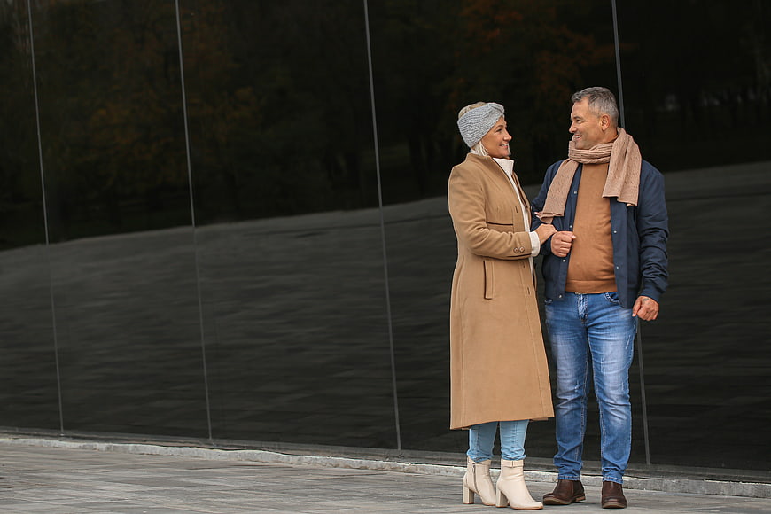 Happy senior couple walking together in autumn fashion