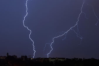 Night Thunderstorm With Lightning Striking Over City Skyline