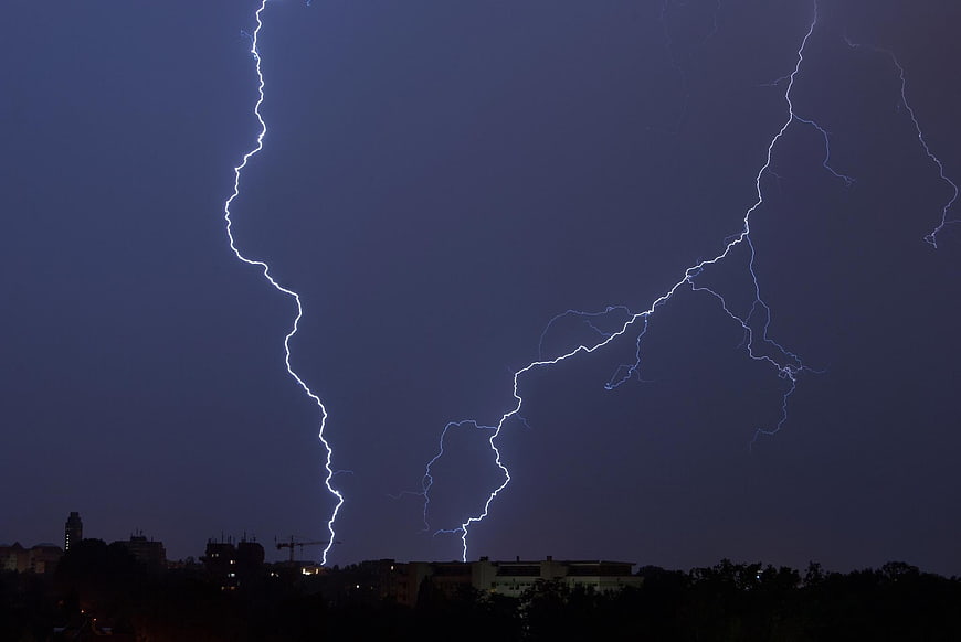 Night Thunderstorm With Lightning Striking Over City Skyline
