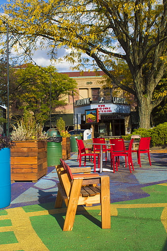 Colorful outdoor plaza with red chairs and painted ground