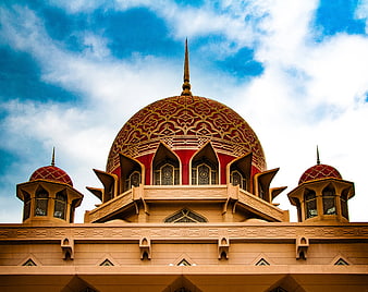 Ornate Red and Gold Mosque Dome Against Blue Sky