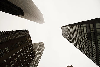 Low angle view of skyscrapers against white sky