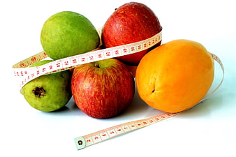 Fresh fruits with measuring tape for healthy diet concept