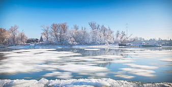 Frozen River Landscape with Ice Floes and Frosty Trees