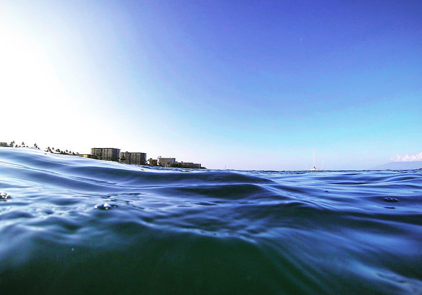 Low angle ocean waves with coastal city skyline background