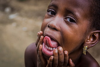 Close-up portrait of African child sticking tongue out
