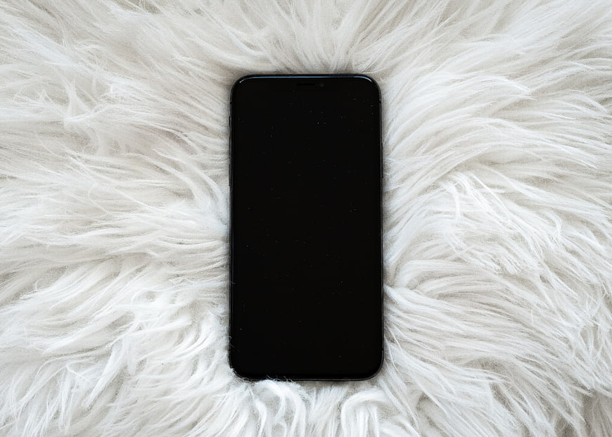 Black Smartphone Mockup on White Fluffy Fur Background