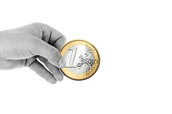 Hand Holding One Euro Coin on White Background