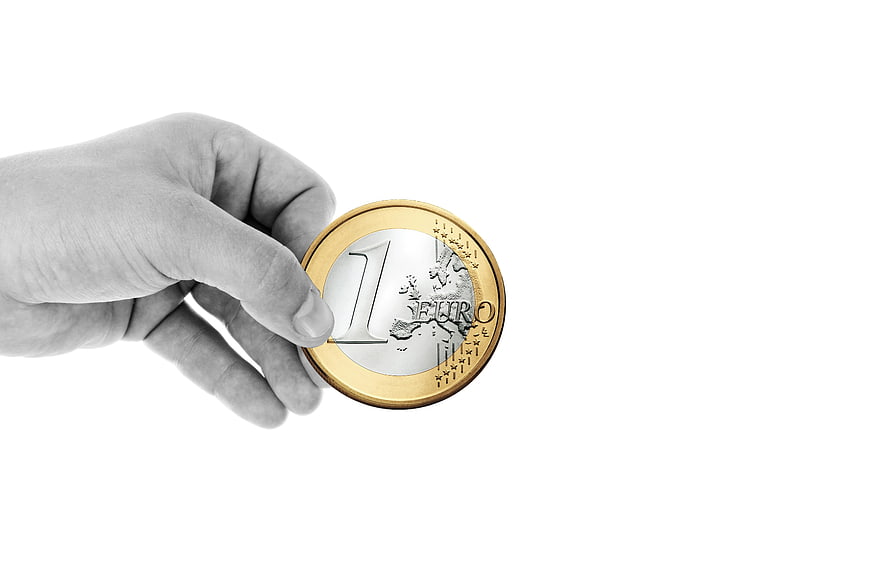 Hand Holding One Euro Coin on White Background