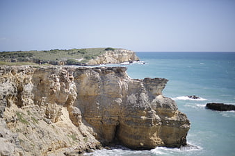 Dramatic coastal cliffs meeting turquoise ocean waters